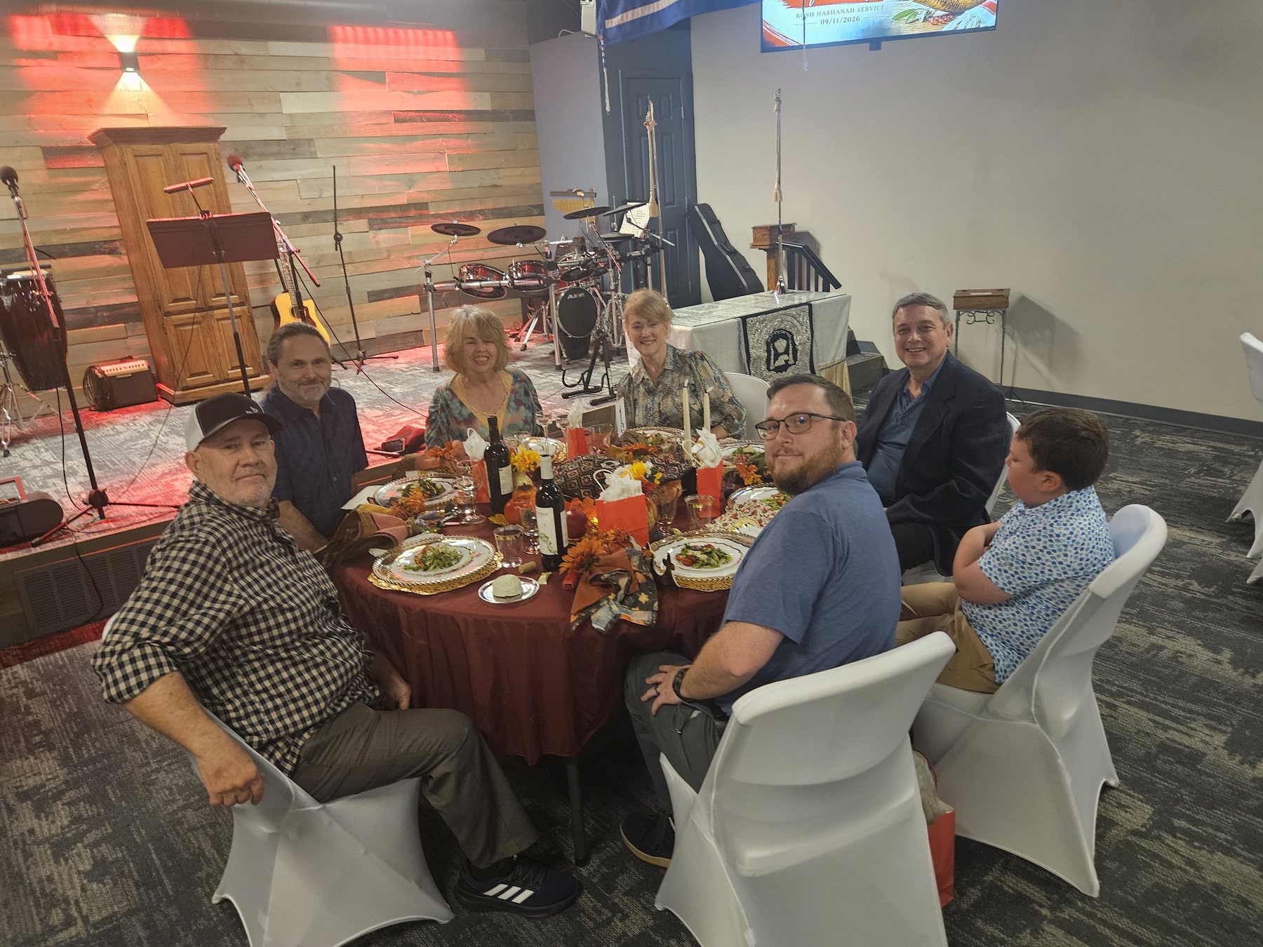 Friends seated around a decorated feast table