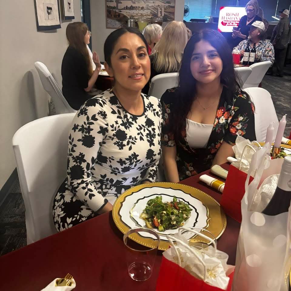 Mother and daughter seated at the feast table