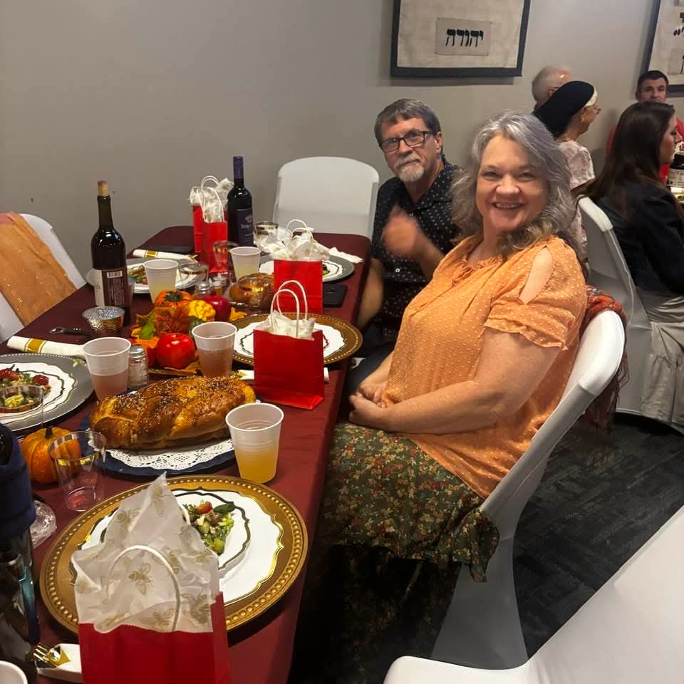 Congregants smiling at the Rosh Hashanah dinner